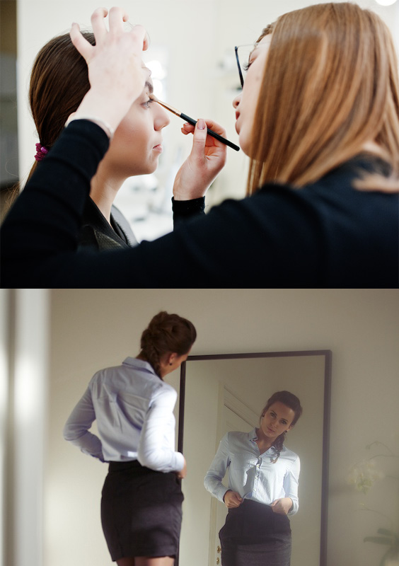 Businesswoman looking at herself in a mirror